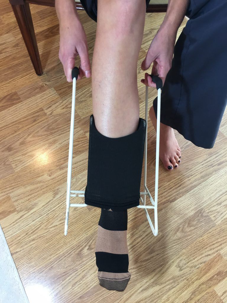 Put on compression socks - pull compression sock over leg using donning tool 