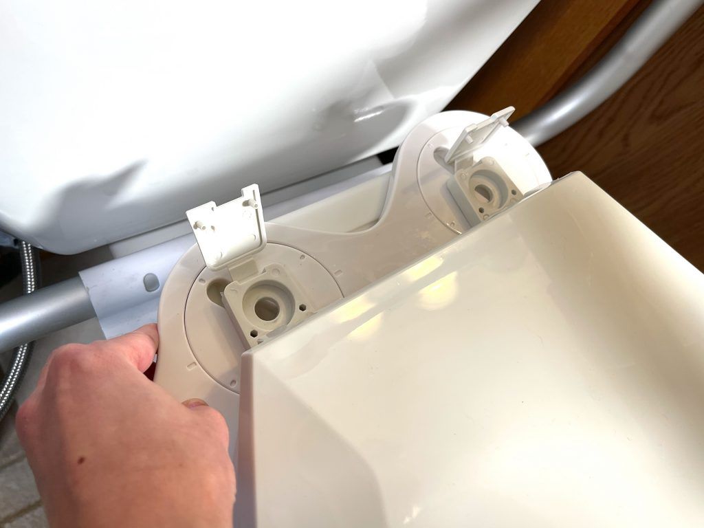 Place toilet seat in position on top of bidet