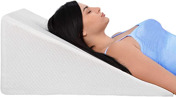 Equipment for Sleeping After Hip Replacement - Woman lying on white wedge pillow