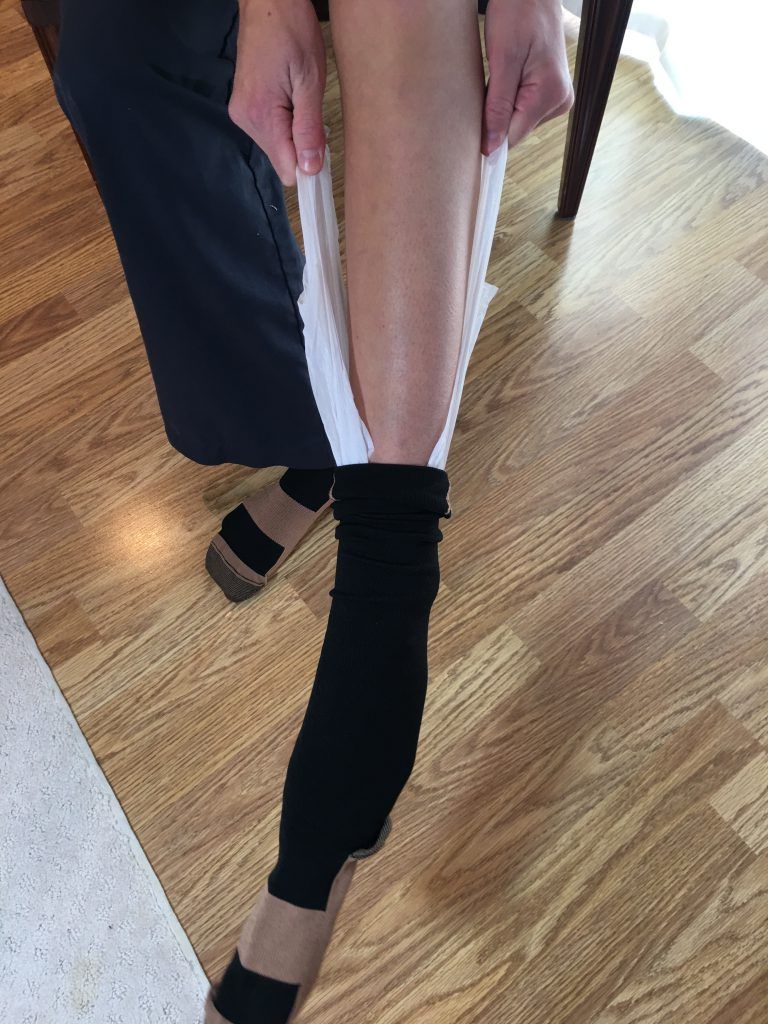 Pull compression sock on using plastic bag