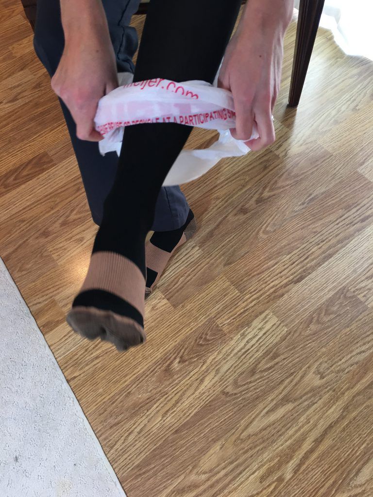 Remove plastic bag after compression sock is on foot Remove plastic bag after compression sock is on foot