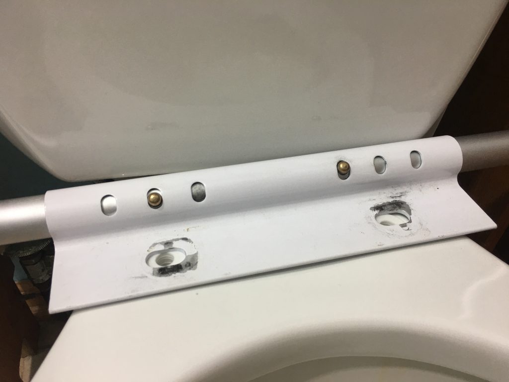 Line up the mounting bracket with toilet seat bolt holes Line up the mounting bracket with toilet seat bolt holes