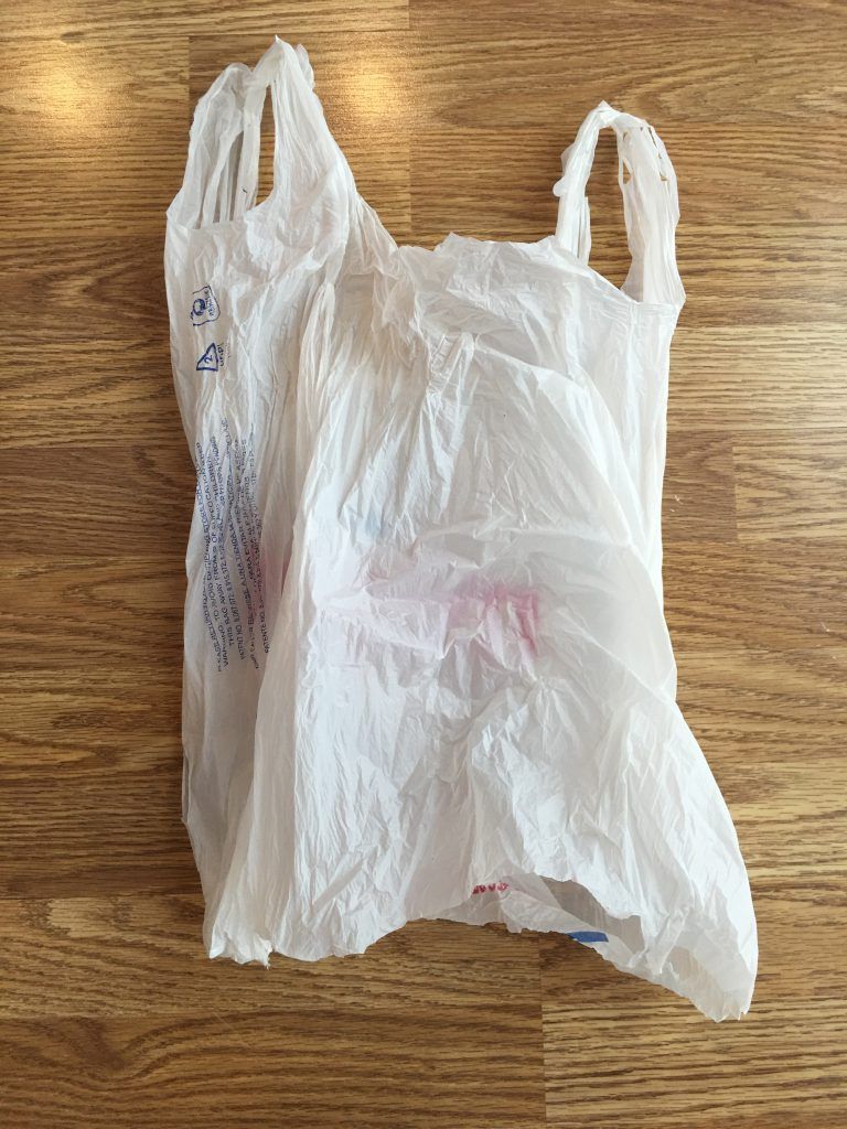 Bottom cut-out of plastic bag for putting on compression sock