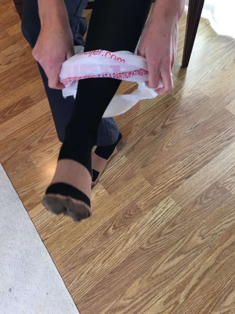 Remove plastic bag after compression sock is on foot Remove plastic bag after compression sock is on foot