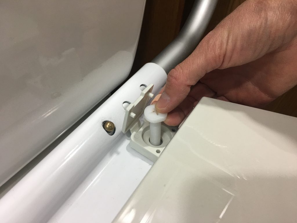 Attaching toilet seat with bolt through mounting bracket Attaching toilet seat with bolt through mounting bracket