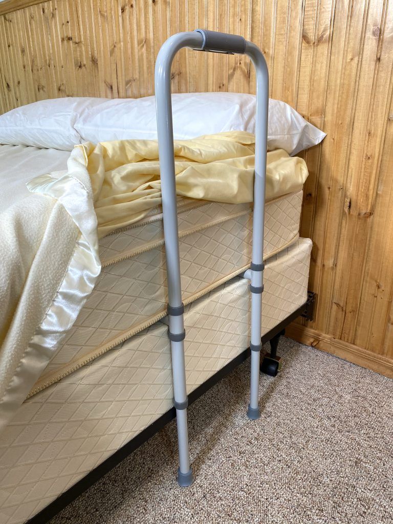 Adult bed rail with feet on floor