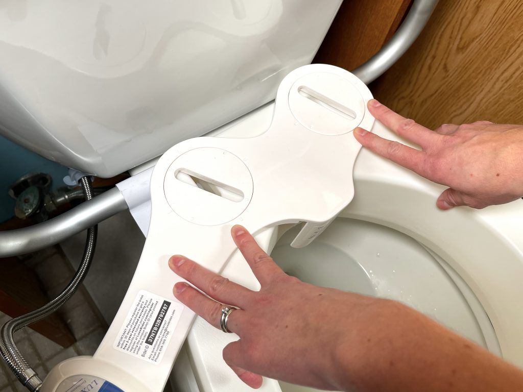 Place bidet on top of raised toilet seat and align mounting holes