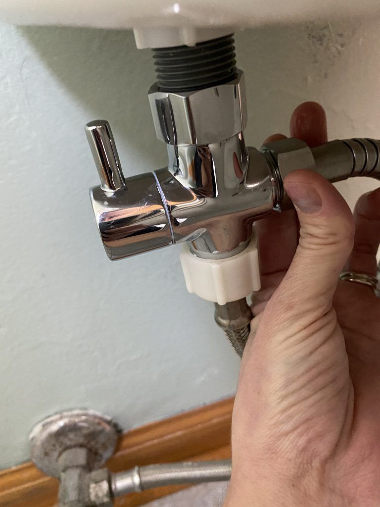 Handheld bidet sprayer hose attachment on T-Valve