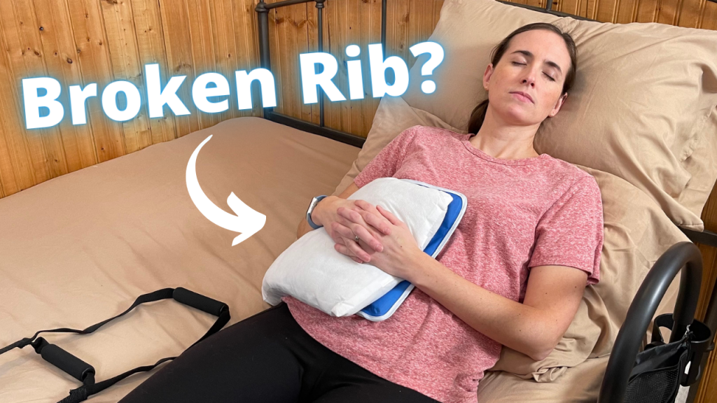 A woman reclines on a bed with her eyes closed, demonstrating a resting position for a potential rib injury. She wears a pink t-shirt and black leggings, cradling a white pillow with a blue border to her chest, suggesting it is providing comfort or support. Large text asking 'Broken Rib?' floats above her, hinting at the context of the image. A bed rail with a storage bag is visible, implying the use of aids for mobility or stability. How to Sleep With Broken Rib or Rib Injury